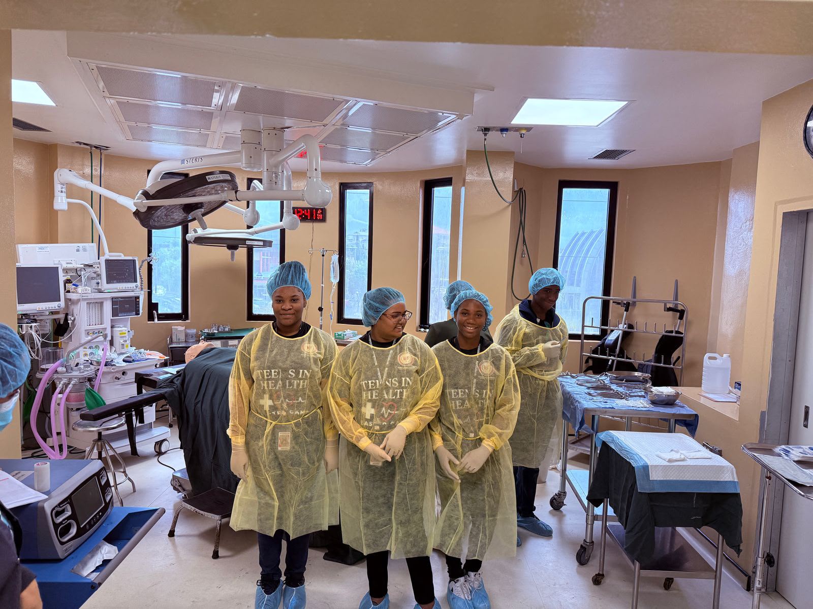 Caribbean teenagers participating in hands-on healthcare activities during the Global Career Institute Teens in Health Easter Camp